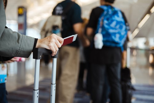 Lady holding a passport at the airport